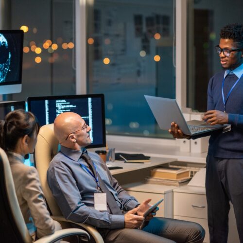 Young successful businessman with laptop making presentation for colleagues Digital Transformation for UAE Healthcare Facilities